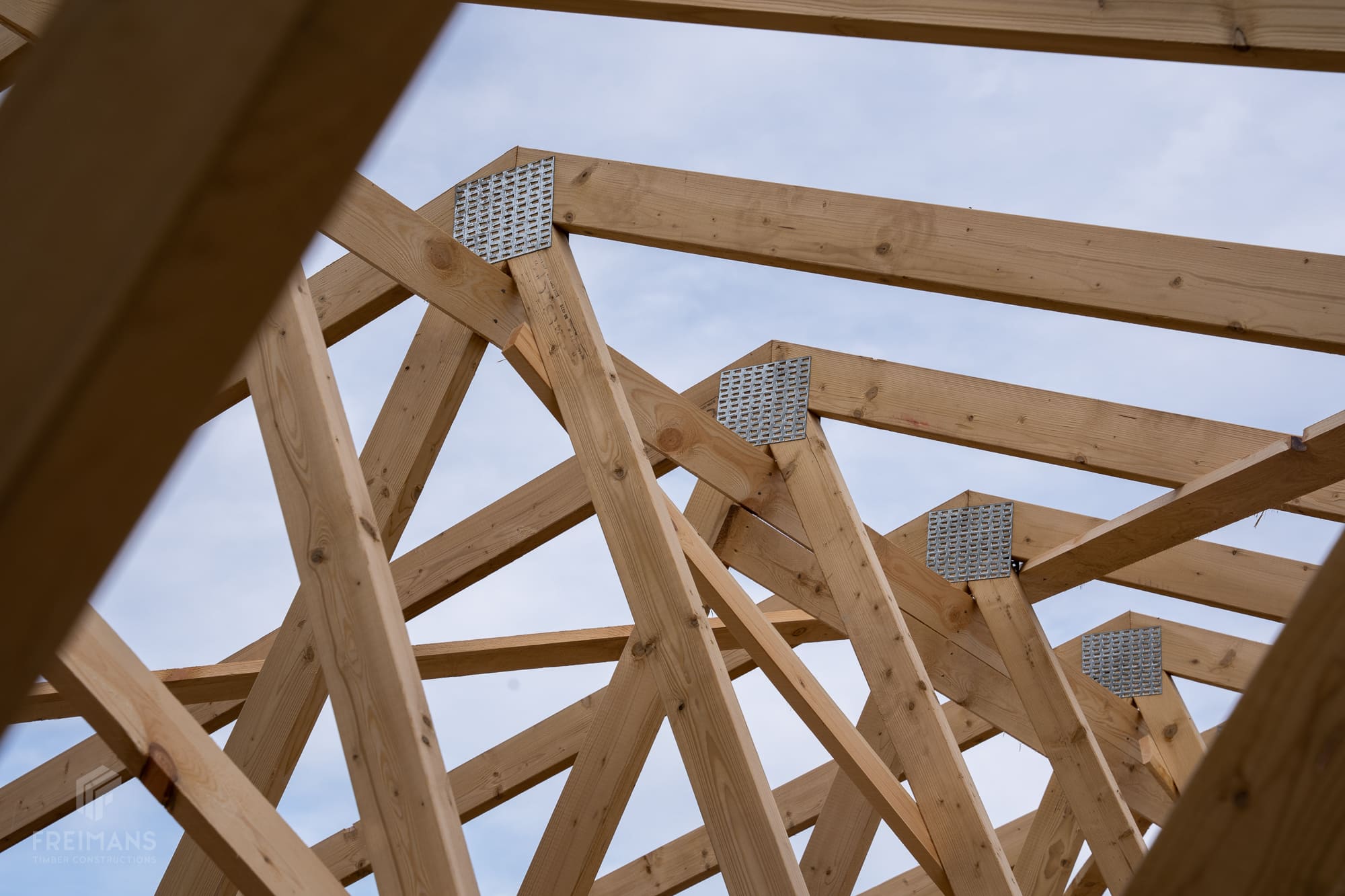 How does the timber price affect the cost of roof trusses?